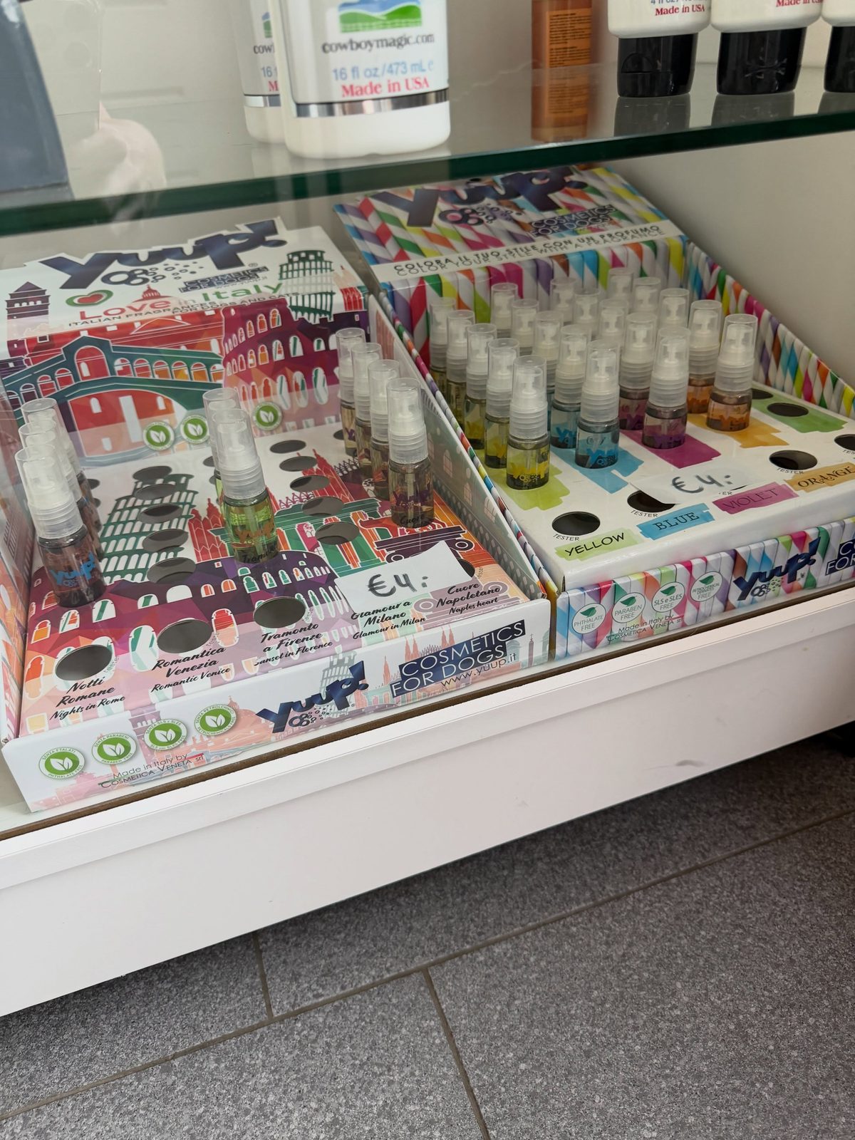Toonbank met kleurrijke flesjes hondenparfum in de salon